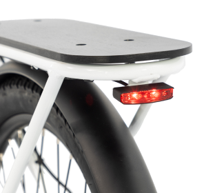 Rear section of a bicycle with a black fender, wooden rack, and red rear light turned on.