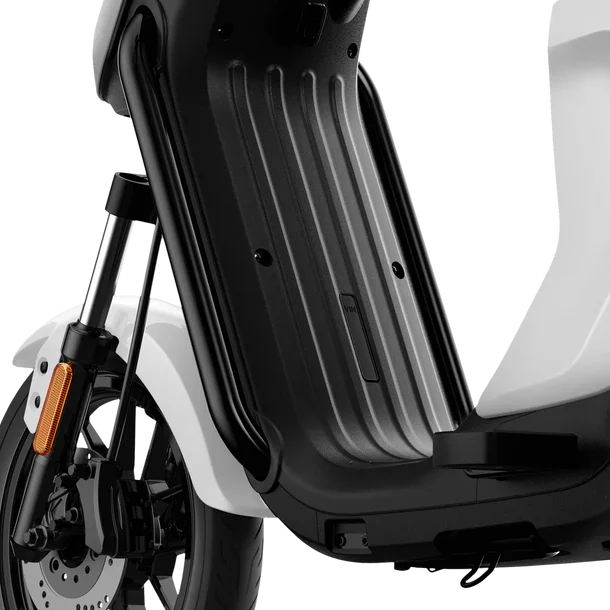 Close-up of the black footboard and front wheel suspension of a white electric scooter.