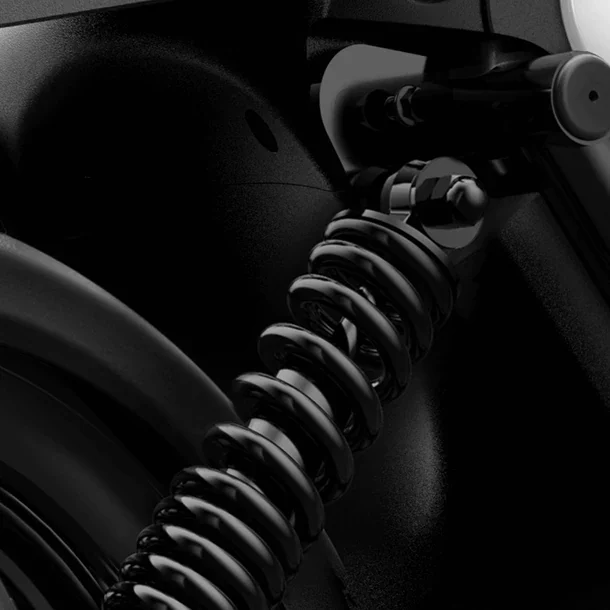 Close-up of a black coil spring suspension component on an electric scooter.